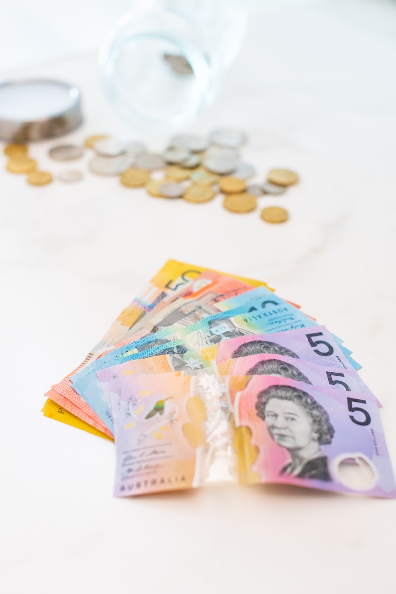 5 Australian banknotes on white textile